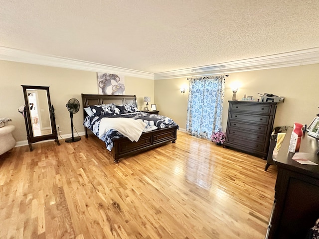 bedroom with crown molding, light hardwood / wood-style flooring, and a textured ceiling