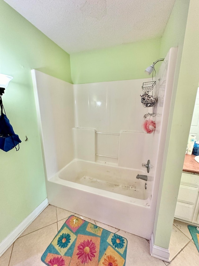 bathroom with tile patterned floors, vanity, a textured ceiling, and bathtub / shower combination