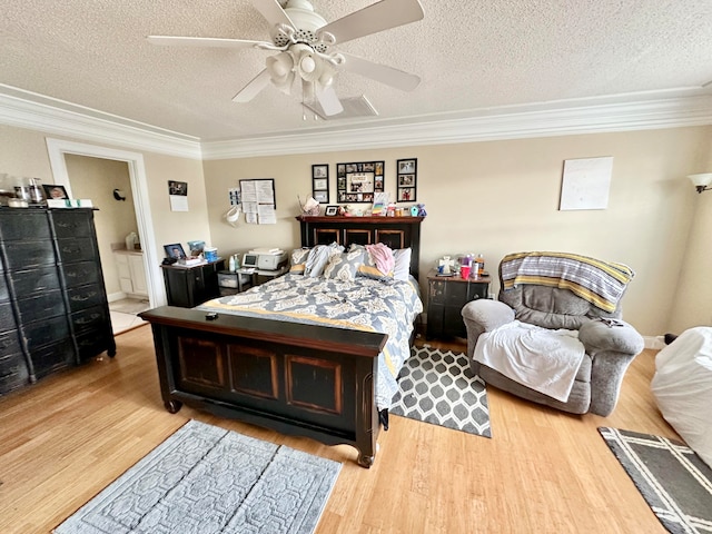 bedroom with ceiling fan, crown molding, a textured ceiling, and light hardwood / wood-style flooring