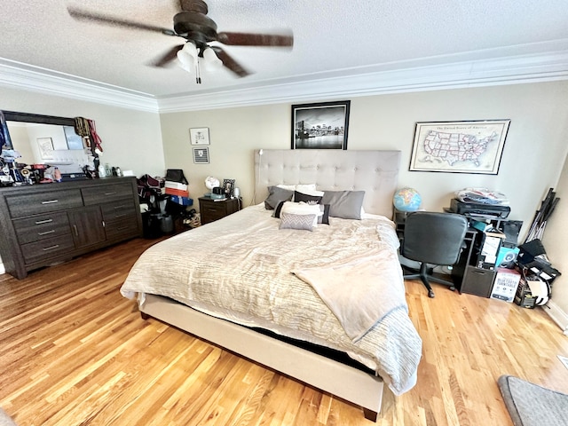 bedroom featuring ceiling fan, hardwood / wood-style floors, crown molding, and a textured ceiling