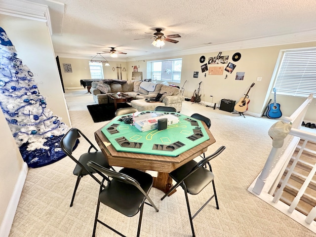 dining area featuring ceiling fan, ornamental molding, light colored carpet, a textured ceiling, and pool table