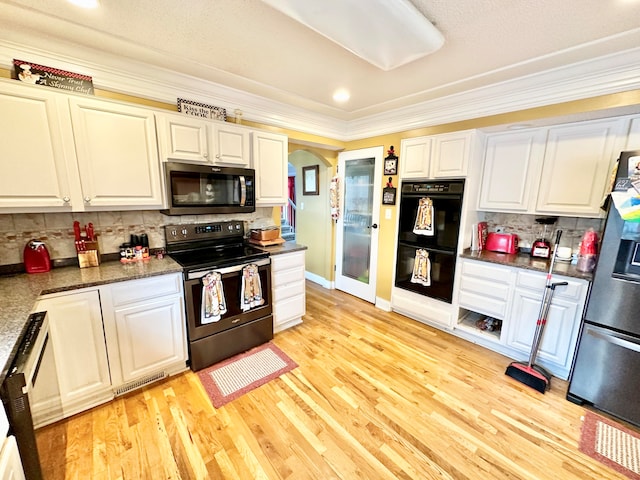 kitchen with decorative backsplash, light hardwood / wood-style flooring, black appliances, and ornamental molding