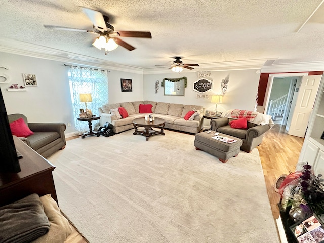 living room with hardwood / wood-style floors, a textured ceiling, ceiling fan, and ornamental molding