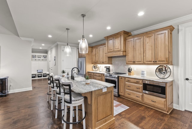 kitchen featuring light stone countertops, stainless steel appliances, dark hardwood / wood-style flooring, decorative light fixtures, and a center island with sink