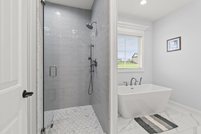 bathroom featuring separate shower and tub