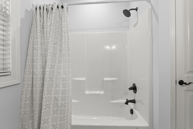 bathroom with shower / bath combo with shower curtain