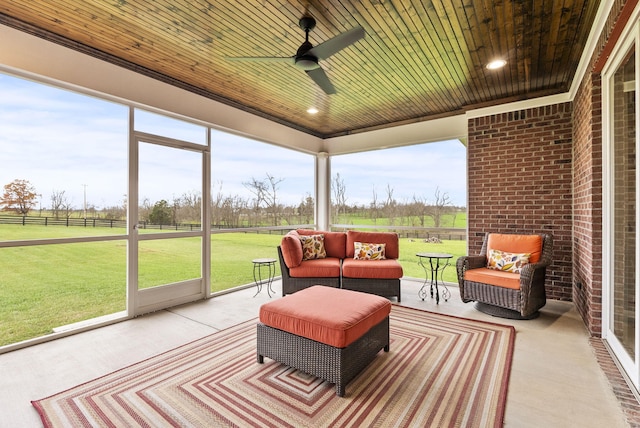 sunroom featuring a wealth of natural light, wooden ceiling, and ceiling fan