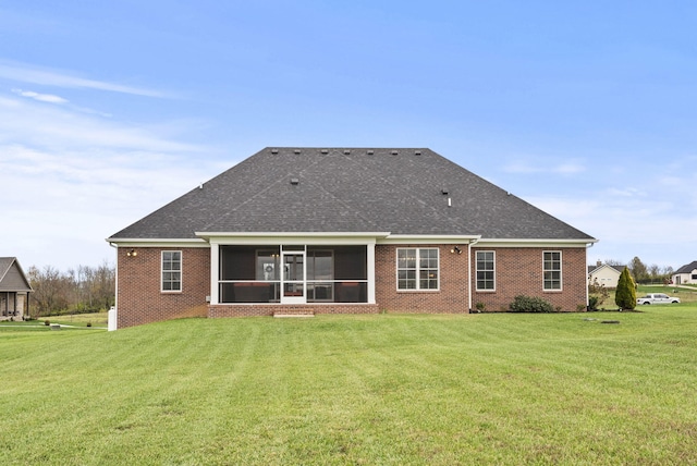 back of property with a sunroom and a lawn