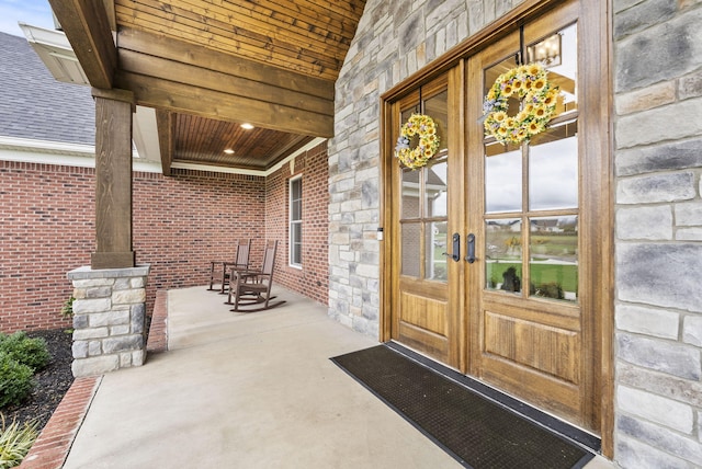 doorway to property with covered porch and french doors