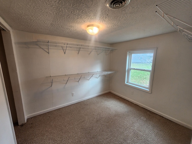 walk in closet featuring carpet