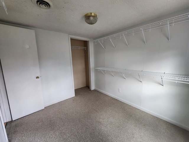 spacious closet featuring carpet floors