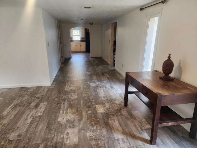 hall with dark hardwood / wood-style flooring