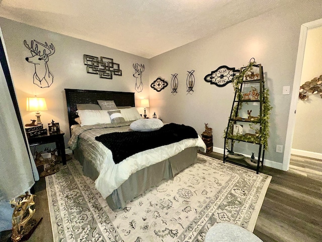 bedroom with hardwood / wood-style floors and a textured ceiling