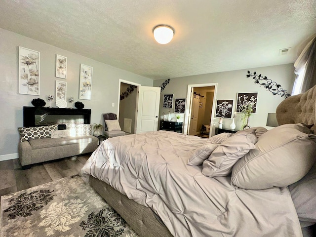 bedroom featuring hardwood / wood-style floors and a textured ceiling