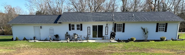 back of house with a lawn