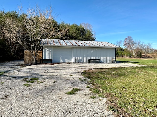 view of outdoor structure featuring a lawn and a garage