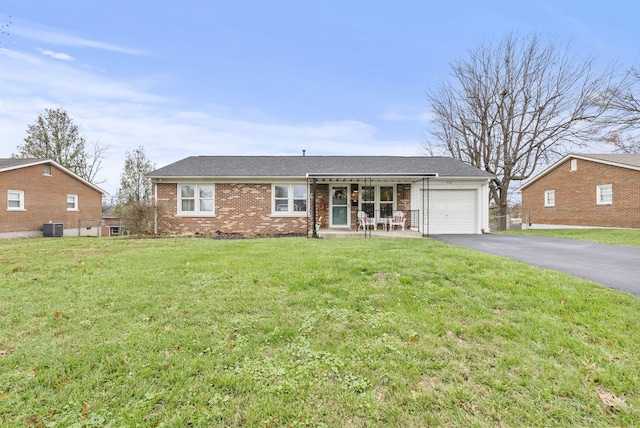 ranch-style home featuring central AC, a garage, and a front yard