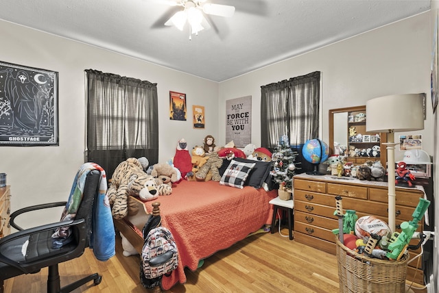 bedroom with light hardwood / wood-style flooring and ceiling fan