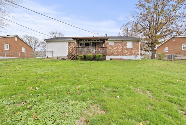 rear view of property with a yard and a deck