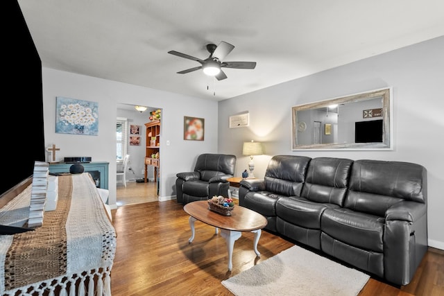 living room with hardwood / wood-style flooring and ceiling fan