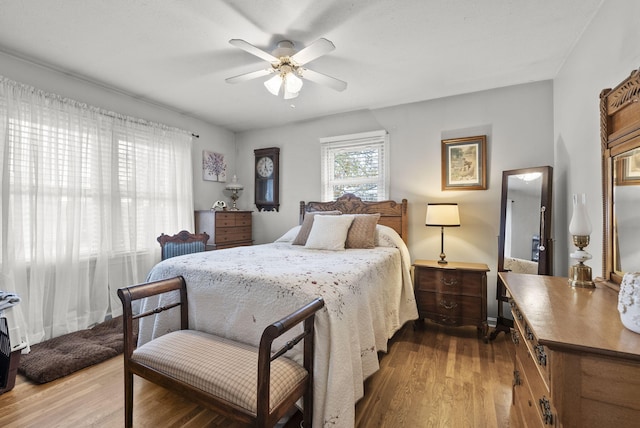 bedroom with wood-type flooring and ceiling fan