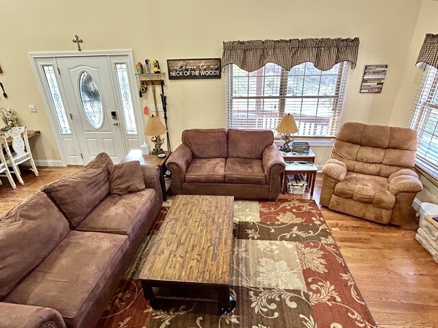 living room featuring ceiling fan, wood-type flooring, and high vaulted ceiling