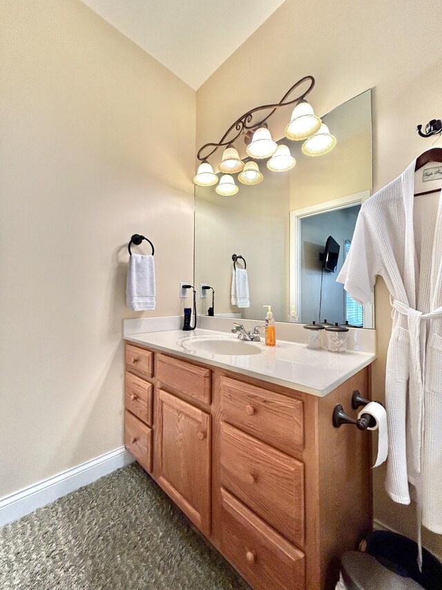 bedroom featuring a barn door, dark hardwood / wood-style floors, ensuite bath, and ceiling fan