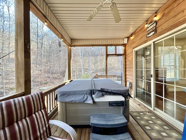 bedroom featuring a barn door, dark hardwood / wood-style floors, and ceiling fan