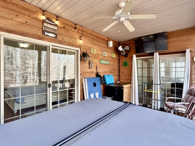 sunroom / solarium featuring ceiling fan and a healthy amount of sunlight