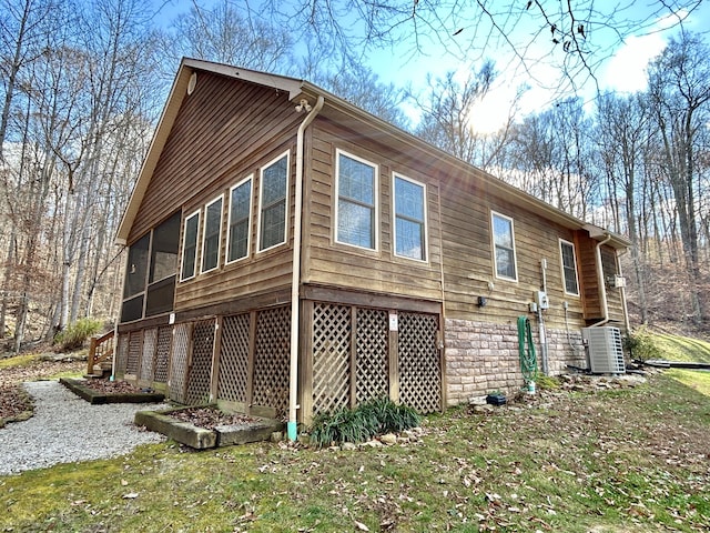 view of property exterior featuring cooling unit and a sunroom