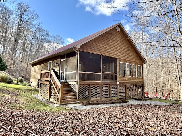 back of property with a sunroom