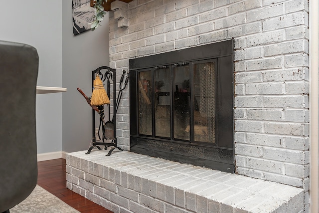 interior details with wood-type flooring and a fireplace