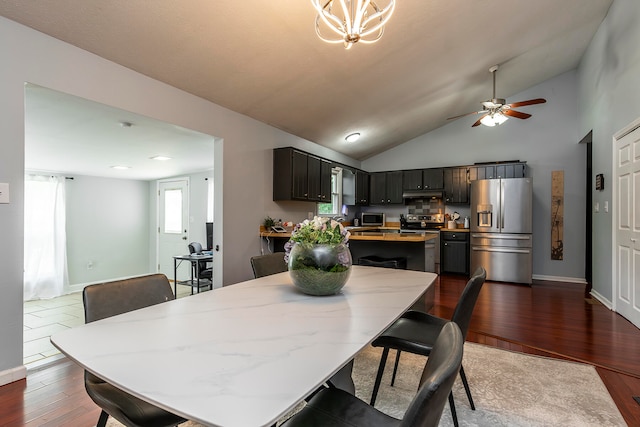 dining room featuring ceiling fan, high vaulted ceiling, and dark hardwood / wood-style floors