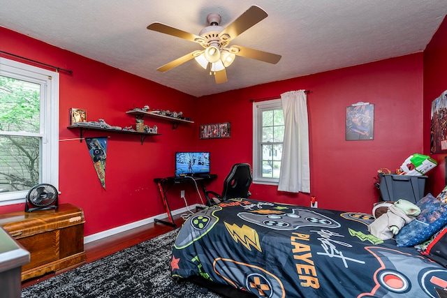 bedroom featuring a textured ceiling, dark hardwood / wood-style flooring, and ceiling fan