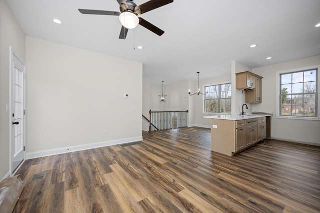 kitchen with dark wood-type flooring, sink, and a healthy amount of sunlight