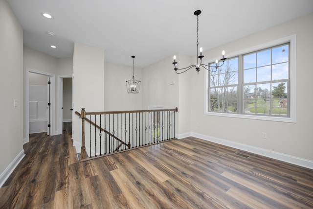 interior space featuring a notable chandelier, dark hardwood / wood-style floors, and a wealth of natural light