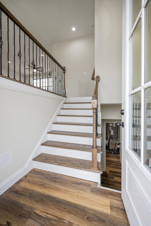 stairs featuring hardwood / wood-style floors