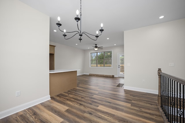 interior space with dark hardwood / wood-style flooring and ceiling fan with notable chandelier