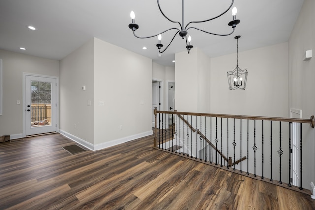 interior space with dark hardwood / wood-style floors and an inviting chandelier