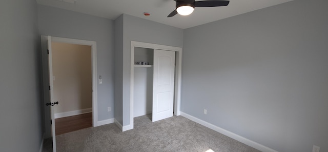 unfurnished bedroom featuring a closet, a ceiling fan, baseboards, and carpet floors