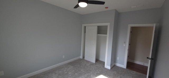 unfurnished bedroom featuring visible vents, baseboards, a ceiling fan, and carpet flooring