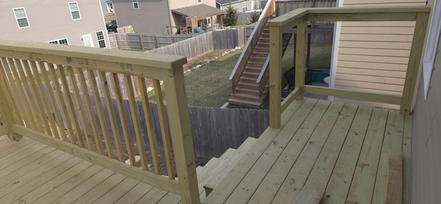 wooden deck featuring stairs, a fenced backyard, and a residential view