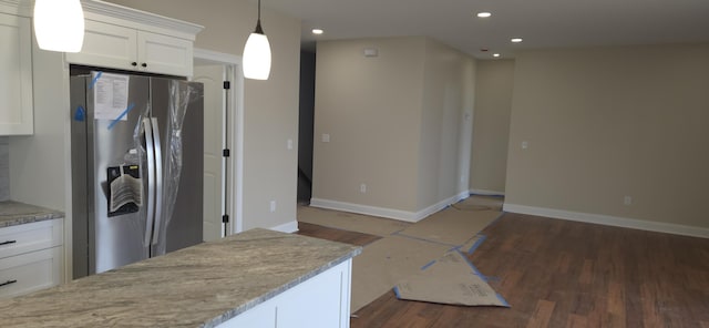 kitchen featuring stainless steel refrigerator with ice dispenser, dark wood-style floors, recessed lighting, white cabinets, and baseboards