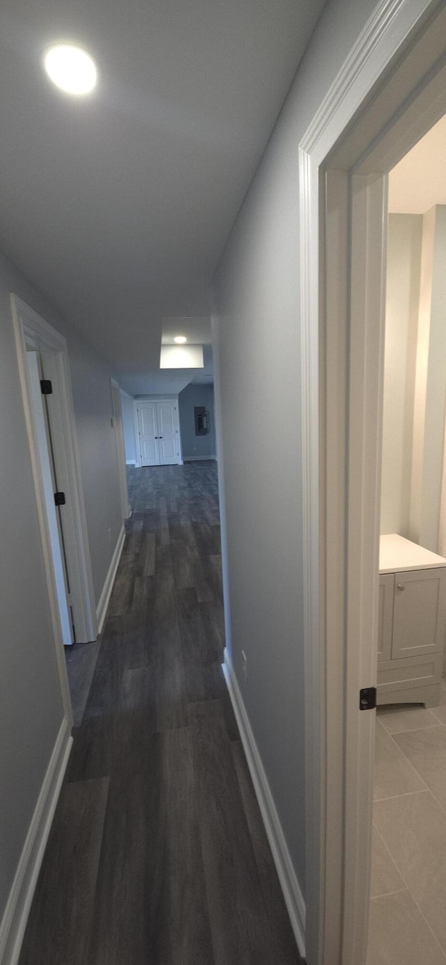 hall with wood finished floors and baseboards