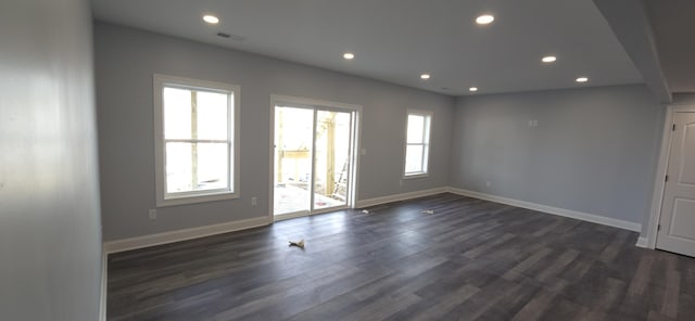 spare room with recessed lighting, visible vents, dark wood-style flooring, and baseboards