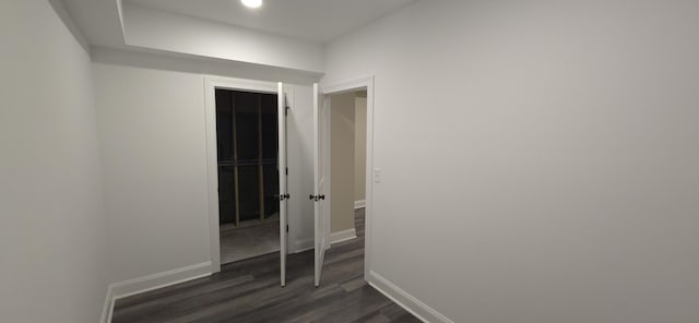 spare room featuring recessed lighting, dark wood-style floors, and baseboards