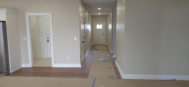 hall featuring recessed lighting, baseboards, and wood finished floors