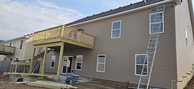 rear view of house with a wooden deck and stairs