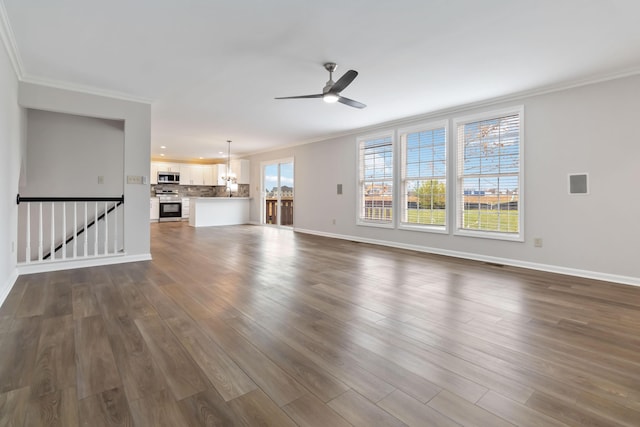 unfurnished living room featuring baseboards, visible vents, a ceiling fan, ornamental molding, and dark wood-style flooring