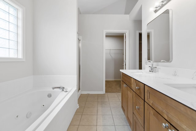 full bath with a sink, a shower stall, tile patterned floors, a whirlpool tub, and double vanity